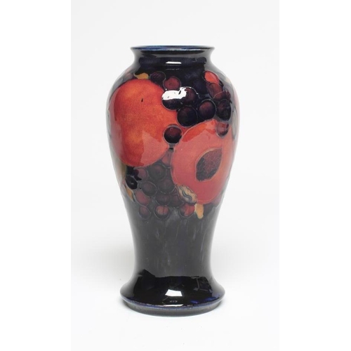 115 - A MOORCROFT POTTERY POMEGRANATE VASE, 1928-1949, of inverted baluster form, painted in typical palet... 