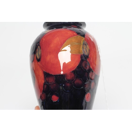 115 - A MOORCROFT POTTERY POMEGRANATE VASE, 1928-1949, of inverted baluster form, painted in typical palet... 