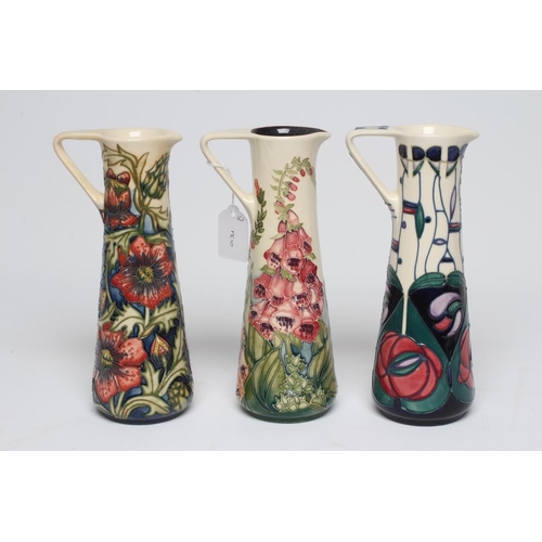 116 - THREE MOORCROFT POTTERY EWERS, comprising Tribute to Rennie Mackintosh, 1996, Amberwood Foxglove, 20... 