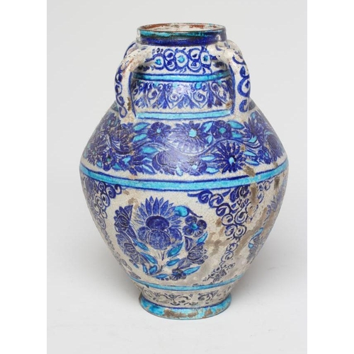 12 - AN INDIAN MULTAN TIN GLAZED EARTHENWARE JAR of conical form with four loop handles, painted in blue ... 