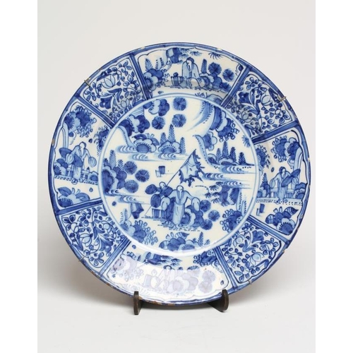 16 - A DUTCH DELFT CHARGER of plain circular form, painted in blue in the Kraak style with a central roun... 