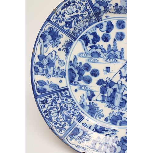 16 - A DUTCH DELFT CHARGER of plain circular form, painted in blue in the Kraak style with a central roun... 