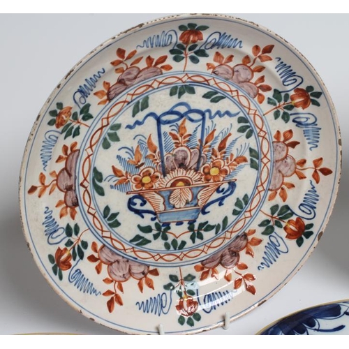 17 - A DUTCH DELFT DISH of plain circular form painted in polychrome enamels with a parrot perched upon a... 