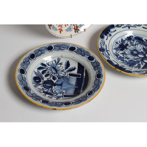 17 - A DUTCH DELFT DISH of plain circular form painted in polychrome enamels with a parrot perched upon a... 