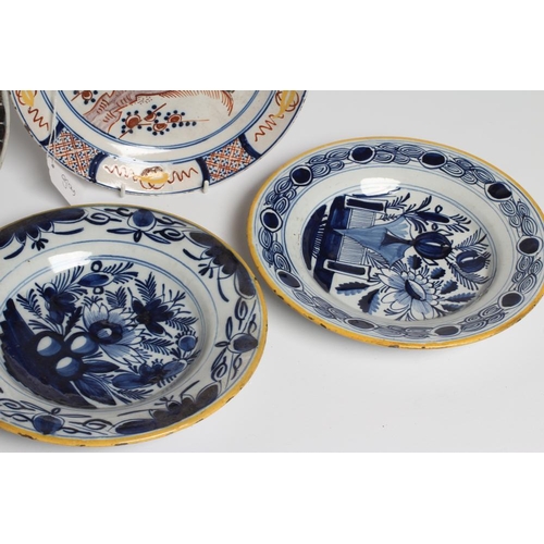 17 - A DUTCH DELFT DISH of plain circular form painted in polychrome enamels with a parrot perched upon a... 