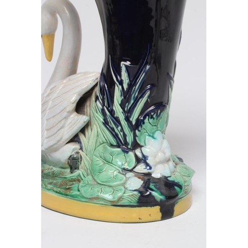 32 - A LATE VICTORIAN JOSEPH HOLDCROFT MAJOLICA VASE modelled as a swan beside a blue glazed cornucopia, ... 