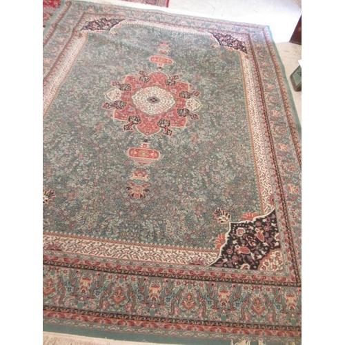 554 - A TURKISH CARPET, modern, the pale green floral ground with central gul in pink, ivory and black wit... 