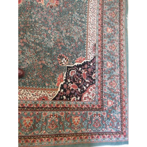 554 - A TURKISH CARPET, modern, the pale green floral ground with central gul in pink, ivory and black wit... 