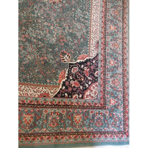 554 - A TURKISH CARPET, modern, the pale green floral ground with central gul in pink, ivory and black wit... 