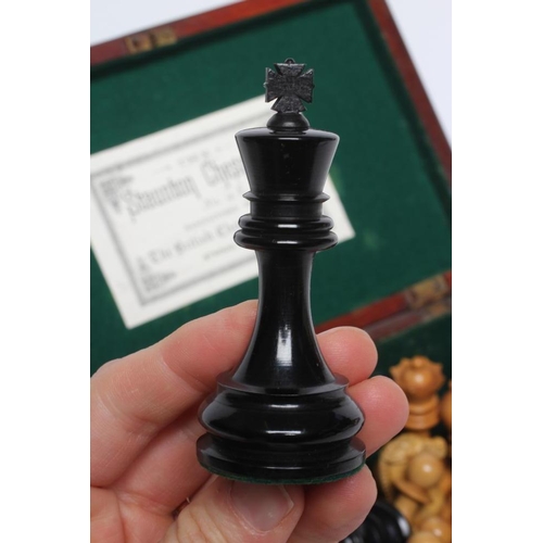 560 - A BOX AND EBONY STAUNTON PATTERN CHESS SET, one white and one black rook and knight with red crown, ... 