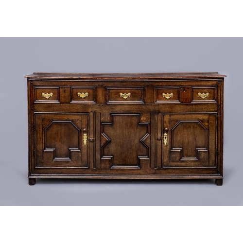 837 - A GEORGIAN OAK DRESSER, probably Yorkshire, early 18th century, the moulded plank lid with plate sta... 