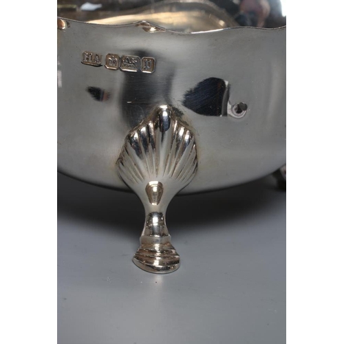 194 - A PAIR OF EDWARDIAN SILVER SAUCEBOATS, maker's mark HA, Sheffield 1907, with shaped everted rims, do... 