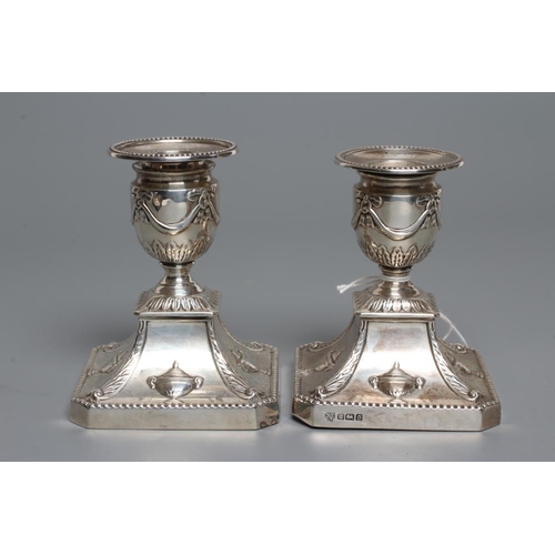 198 - A COMPOSITE PAIR OF EDWARDIAN SILVER DWARF CANDLESTICKS, maker Hawkesworth, Eyre & Co., Sheffield 19... 