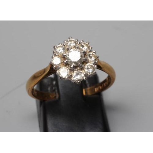 304 - A DIAMOND CLUSTER RING, the central brilliant cut stone of approximately 0.20cts within a border of ... 