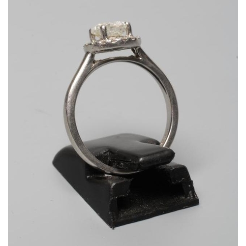 312 - A DIAMOND CLUSTER RING, the central brilliant cut stone of approximately 0.80cts claw set to an open... 