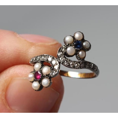 318 - A GEORGIAN STYLE RING, the two off-set flower heads centred by a close back set blue and red stone w... 