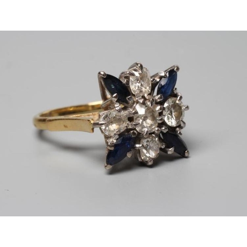 320 - A SAPPHIRE AND DIAMOND DRESS RING, the central cushion cut diamond claw set within a border of four ... 