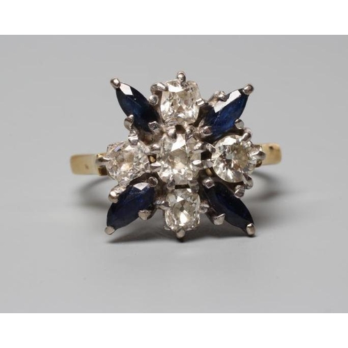 320 - A SAPPHIRE AND DIAMOND DRESS RING, the central cushion cut diamond claw set within a border of four ... 