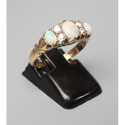 393 - A LATE VICTORIAN OPAL AND DIAMOND RING, the three oval cabochon polished opals claw set with two pai... 