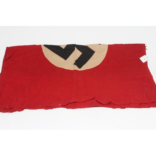 422 - A GERMAN THIRD REICH FLAG of typical form with red ground and central swastika, one sided, 38