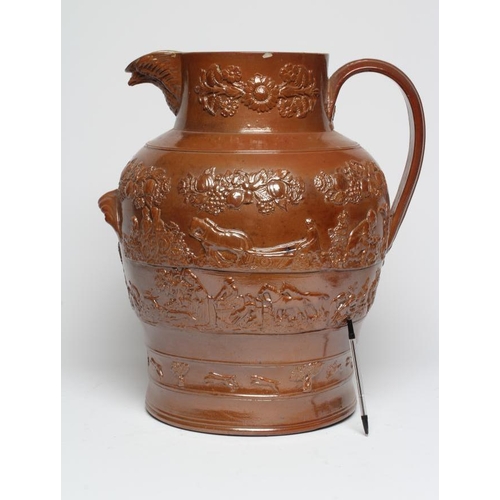 39 - A LARGE SALTGLAZE STONEWARE HARVEST JUG, mid 19th century, of baluster form with hand support below ... 