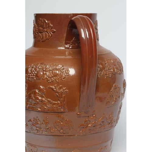 39 - A LARGE SALTGLAZE STONEWARE HARVEST JUG, mid 19th century, of baluster form with hand support below ... 