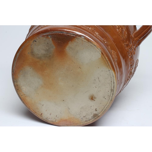 39 - A LARGE SALTGLAZE STONEWARE HARVEST JUG, mid 19th century, of baluster form with hand support below ... 