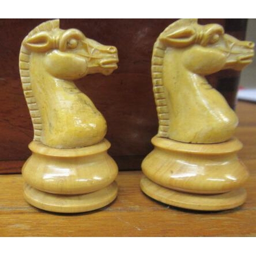 560 - A BOX AND EBONY STAUNTON PATTERN CHESS SET, one white and one black rook and knight with red crown, ... 