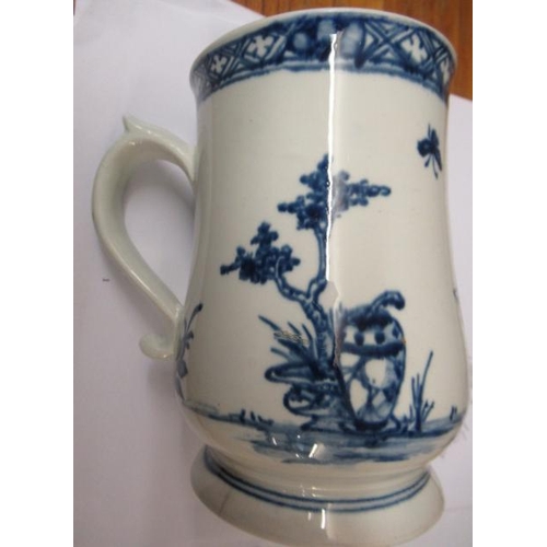 63 - A VAUXHALL PORCELAIN MUG, 1755-60, of baluster form painted in underglaze blue with a small child st... 