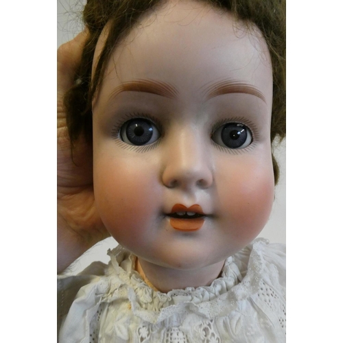 103 - A Schoenau & Hoffmeister bisque socket head doll, with blue glass sleeping eyes, open mouth, teeth, ... 