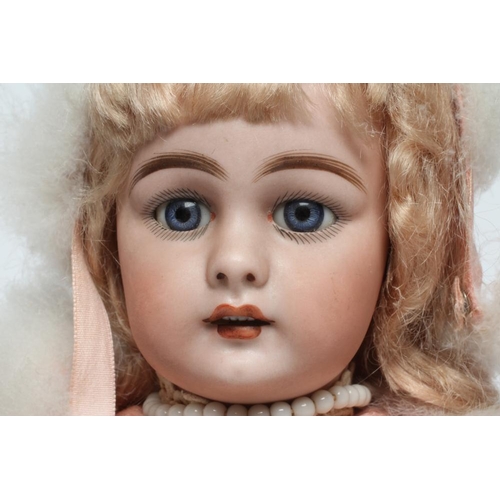 12 - A Simon & Halbig bisque socket head doll, with blue glass fixed eyes, open mouth, teeth, pierced ear... 