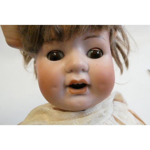 16 - A C.M. Bergmann bisque socket head character doll, with brown glass sleeping eyes, open mouth, appli... 