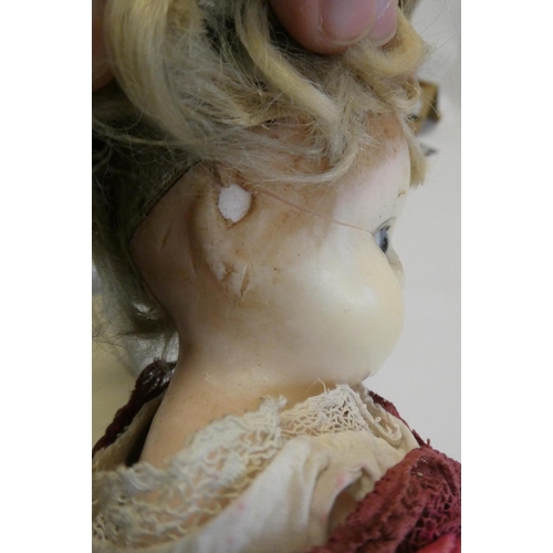 18 - A Victorian wax shoulder head doll, with blue glass eyes, blond hair, closed mouth, kid body and ori... 