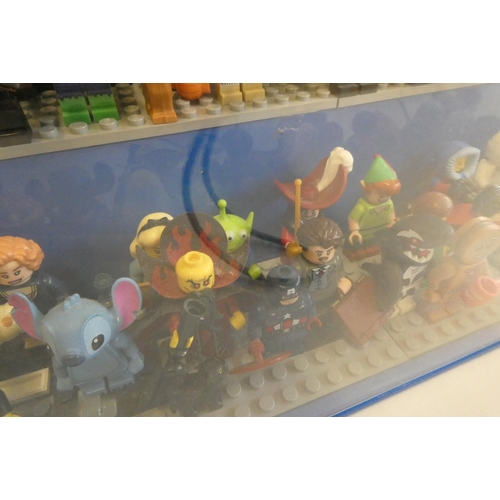 229 - A perspex display case of Lego figures, comprising 68 characters, 3 cats, an owl and a penguin, inlc... 