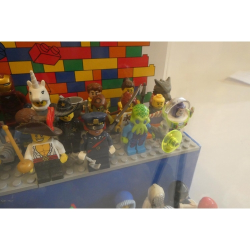 229 - A perspex display case of Lego figures, comprising 68 characters, 3 cats, an owl and a penguin, inlc... 