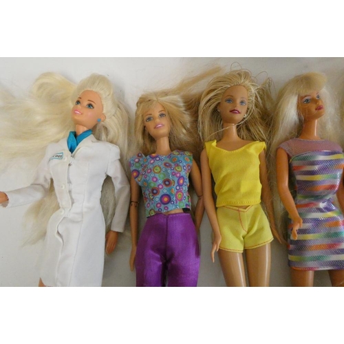 26 - Twelve Barbie dolls, comprising ten Barbies, two younger sisters and a Barbie camera