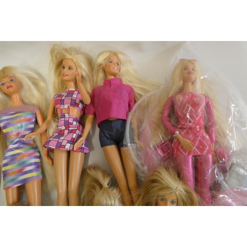 26 - Twelve Barbie dolls, comprising ten Barbies, two younger sisters and a Barbie camera