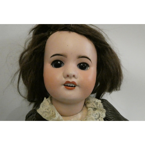 27 - An SFBJ bisque socket head doll, with brown glass sleeping eyes, open mouth, teeth, brown wig, wood ... 