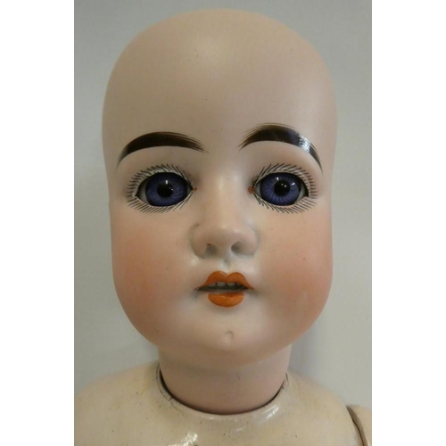 32 - An Arthur Schoenau bisque socket head doll, with blue glass fixed eyes, open mouth, teeth, wood and ... 