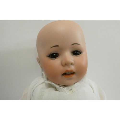 38 - A German bisque socket head doll, with brown glass sleeping eyes, oepn mouth, teeth, bent limb compo... 