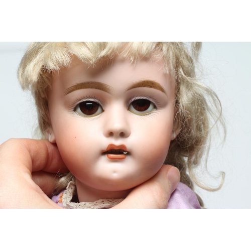 4 - A bisque socket head doll, c.1900, with brown glass sleeping eyes, open mouth, teeth, pierced ears, ... 