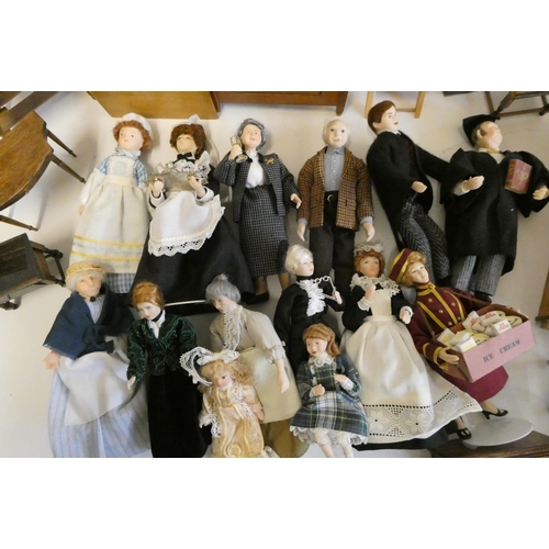 67 - A collection of doll's house furniture and dolls, including wardrobes, dining tables chairs, chests ... 