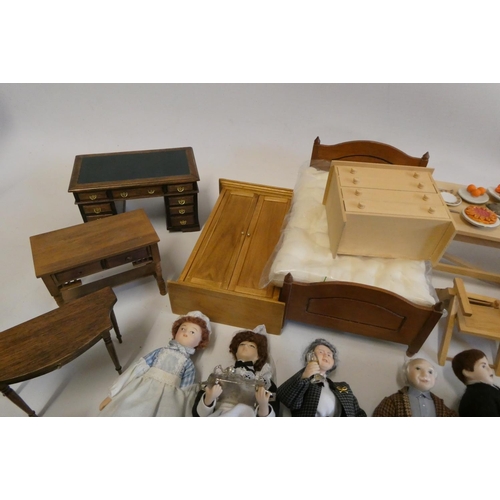 67 - A collection of doll's house furniture and dolls, including wardrobes, dining tables chairs, chests ... 