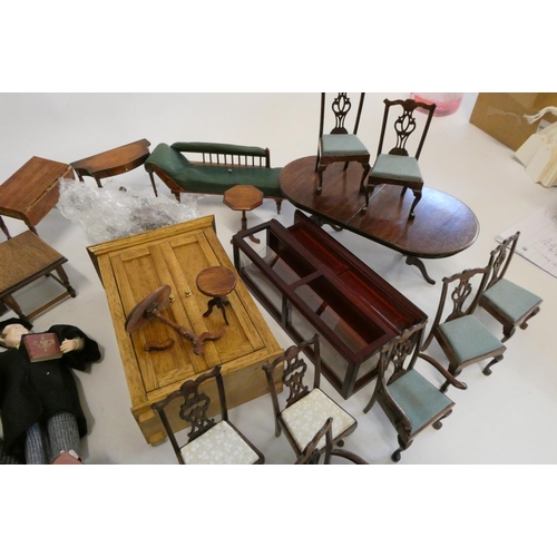 67 - A collection of doll's house furniture and dolls, including wardrobes, dining tables chairs, chests ... 