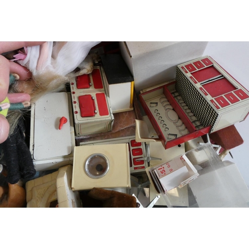 82 - A box of dolls house furniture, dolls and accessories, including a large model telephone box, rugs a... 