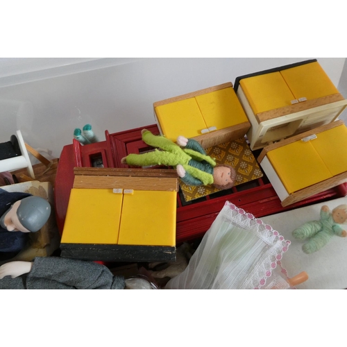 82 - A box of dolls house furniture, dolls and accessories, including a large model telephone box, rugs a... 