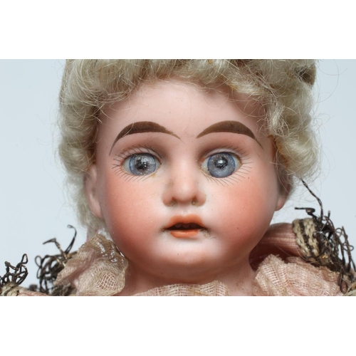 93 - A Marotte bisque shoulder head doll, with blue glass fixed eyes, open mouth, teeth, blond wig, typic... 