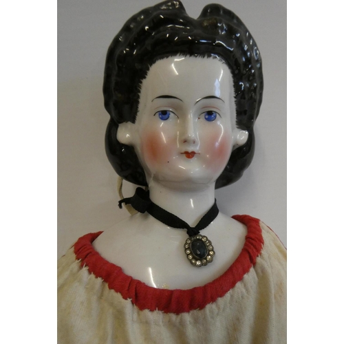 94 - A china shoulder head doll, c.1880, with moulded hair, painted features, china lower limbs, moulded ... 