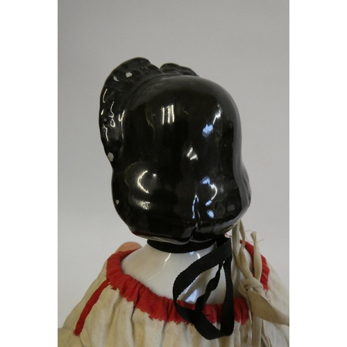 94 - A china shoulder head doll, c.1880, with moulded hair, painted features, china lower limbs, moulded ... 