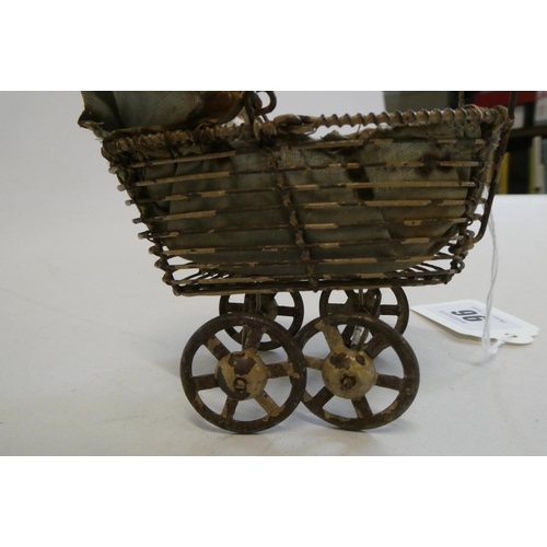 96 - A pre-war filigree dolls house pram, with fabric hood and liner, 4 1/2